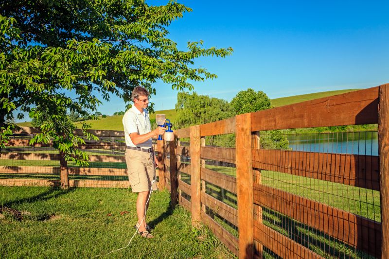 Applying Stain on Cedar Fence